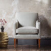 Bespoke, handmade armchair in linen with leather piping. - Beaumont & Fletcher