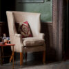 Bespoke, handmade armchair in leather with embroidered cushion. - Beaumont & Fletcher