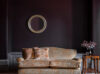 A luxury, bespoke sofa in velvet with a round silver mirror and two hand embroidered cushions - Beaumont & Fletcher