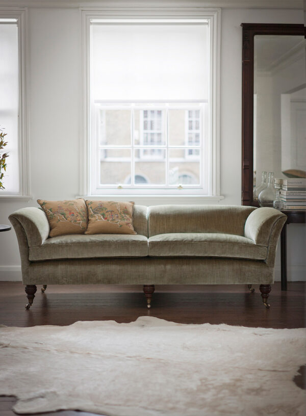 Whimsical, chinoiserie hand embroidered cushion design in golden silk with a bespoke sofa.