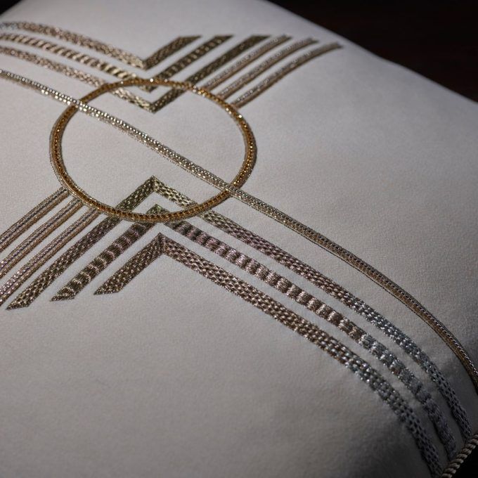 Hand embroidered, art deco inspired cream wool cushion.