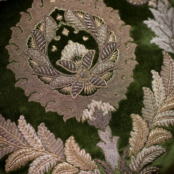 The hand embroidered details of a luxurious cushion