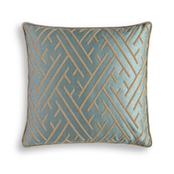 A blue silk cushion with a linear hand embroidery design on the front