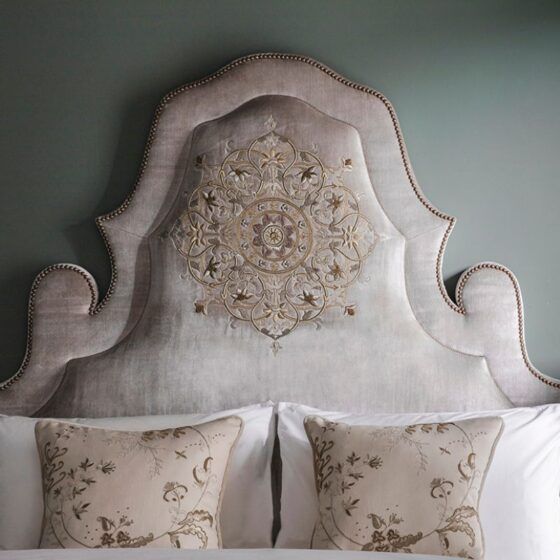 A luxurious, bespoke headboard with an intricate hand embroidery design