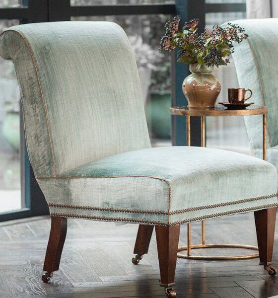 a handcrafted slipper chair in a luxurious pale green silk velvet