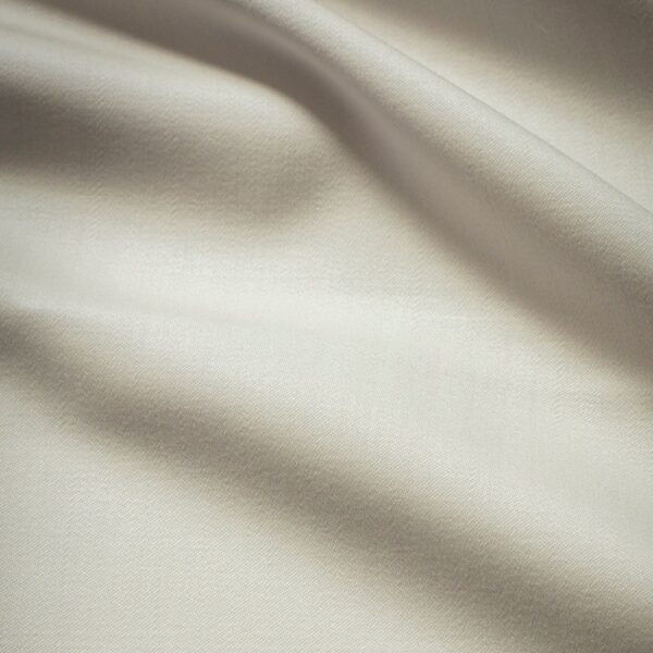 A swatch of a luxurious off white wool fabric