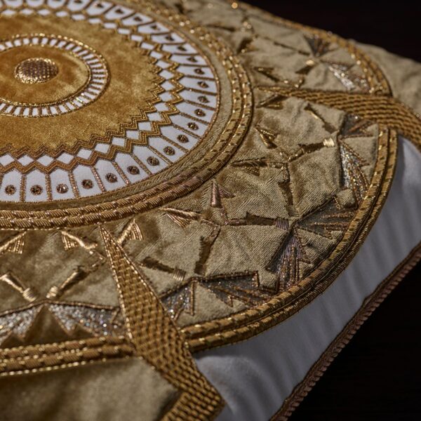 A highly decorative, hand embroidered cushion with metallic threads and applique