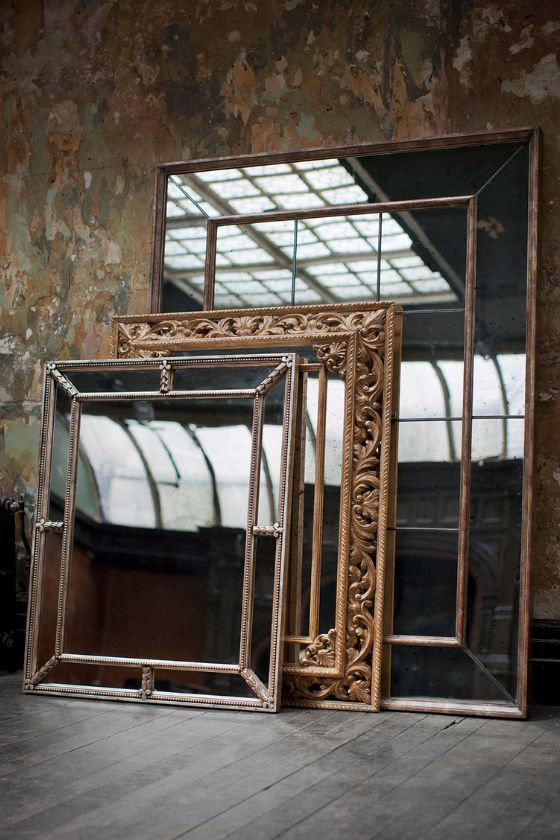 A collection of ornate, antique style mirrors in various hand gilded finishes.