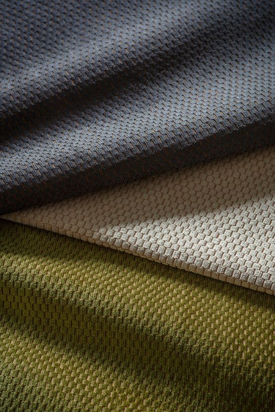 A swatch of textured velvet upholstery fabric in a range of colours.