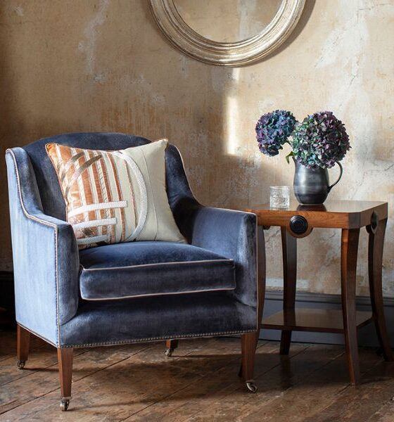 An art deco style armchair in a luxurious blue silk velvet